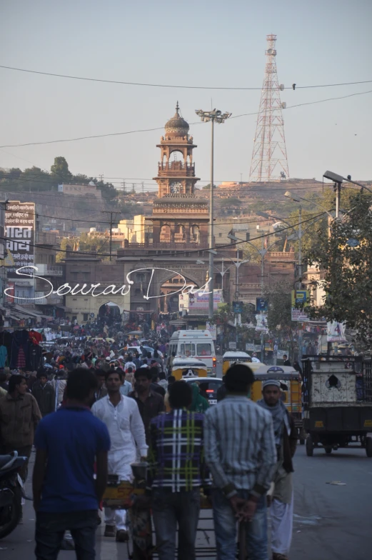 people walking along a busy street in india