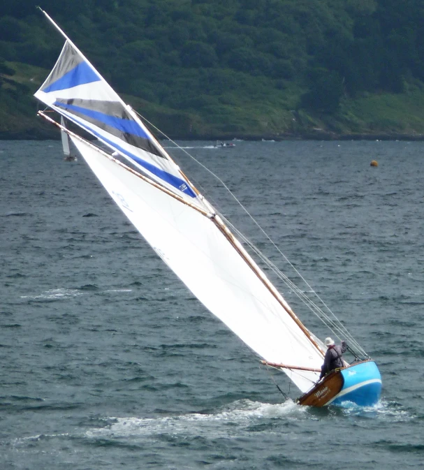 a man riding on the back of a wind sail boat