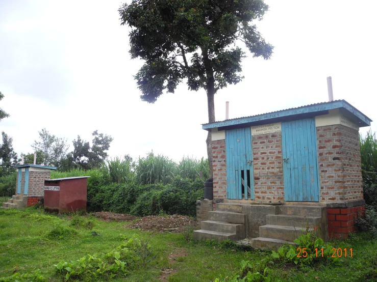 several outhouses on the side of a small hill