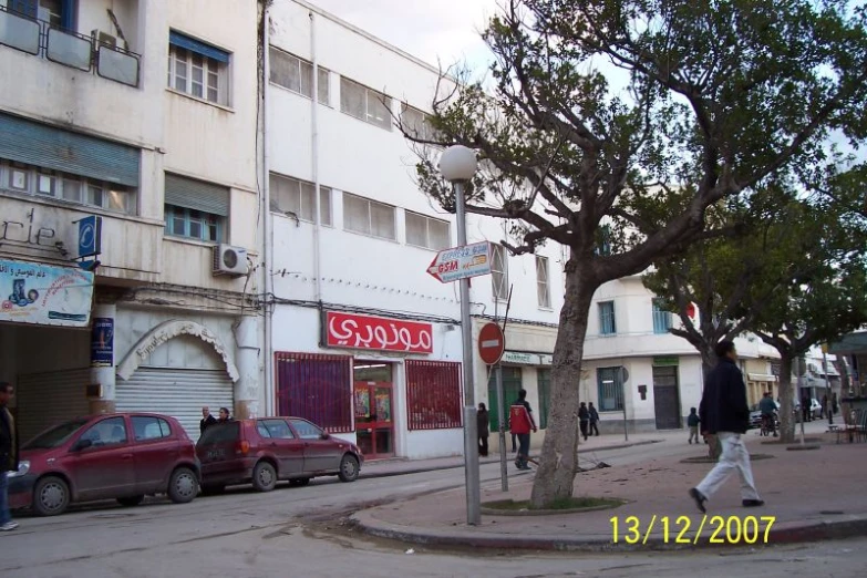 street scene with cars on the road, pedestrians on the sidewalk and pedestrians walking down a sidewalk