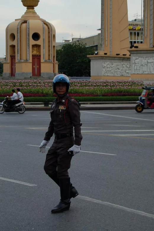 the man is dressed in his uniform and standing in the parking lot