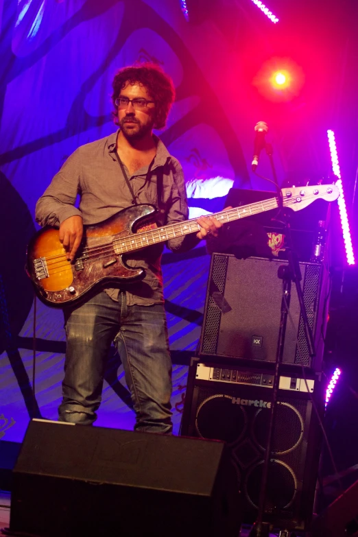 a person that is playing guitar on a stage