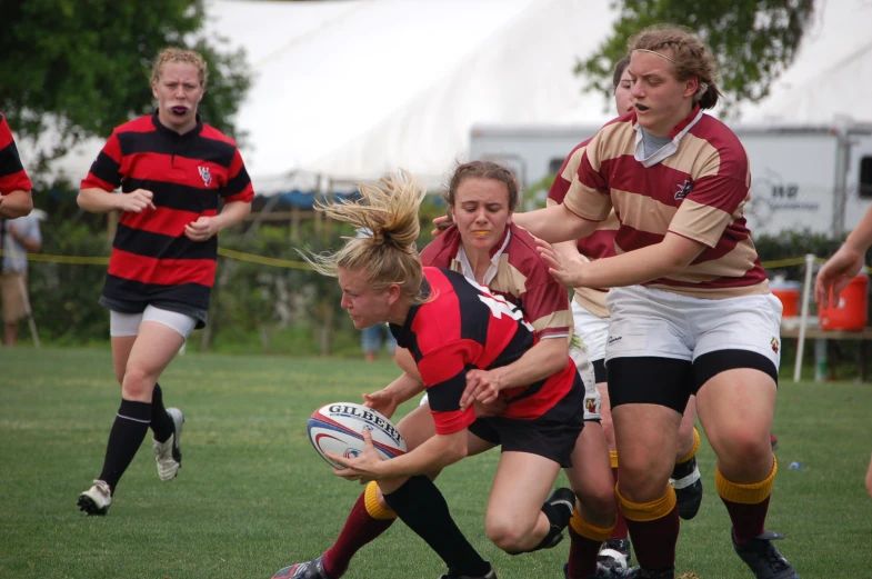 a group of young women playing a game of rugby