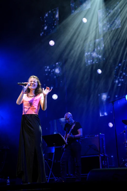 the woman is performing on the stage alone