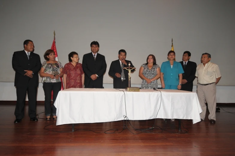 a group of people are posing behind a table