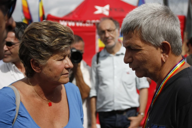 two people staring at each other near people