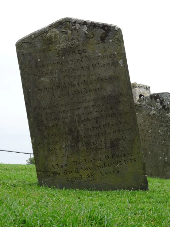 an old cemetery with grass in the foreground