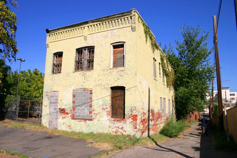 an old, yellow brick building is empty and vacant