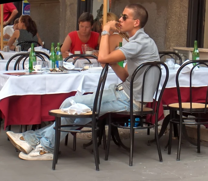 a person sitting at an outside table