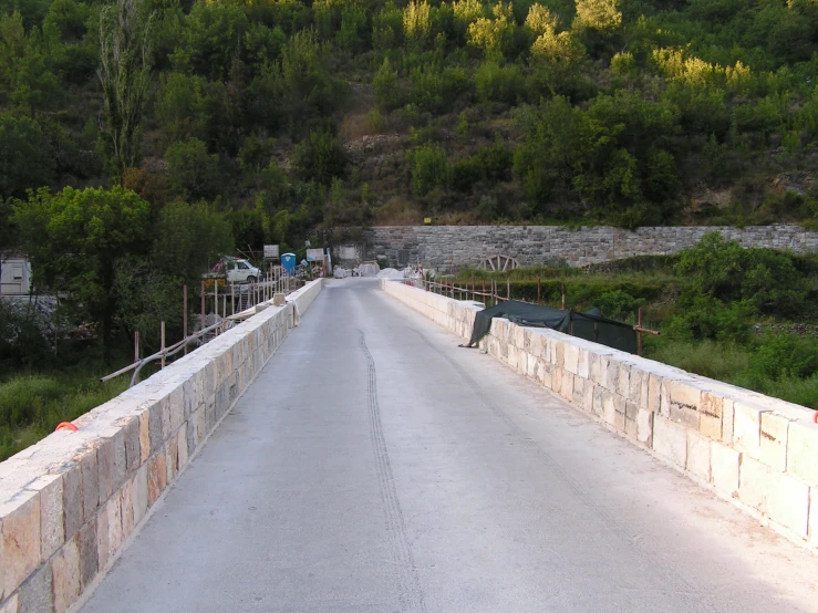 the man is jumping over a bridge near the road