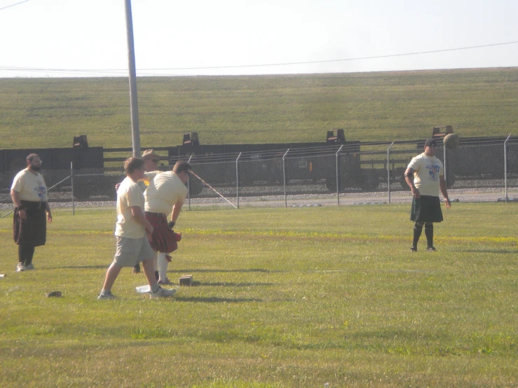 a group of people standing in the grass