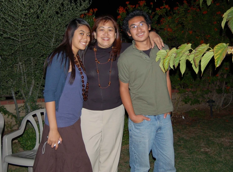 two men and a woman smiling for the camera