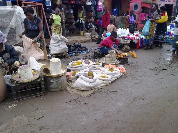 a man selling goods for sale at an outdoor market