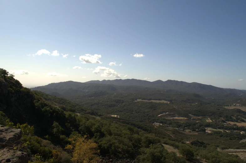 a scenic view of a valley from a hill