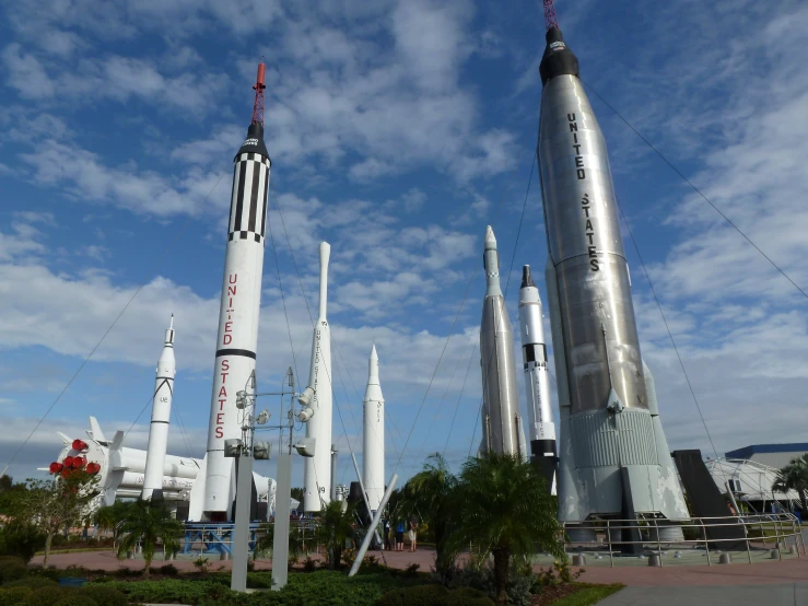 several different sized rockets sitting on display in a park