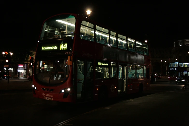 a double decker bus that is going through the street