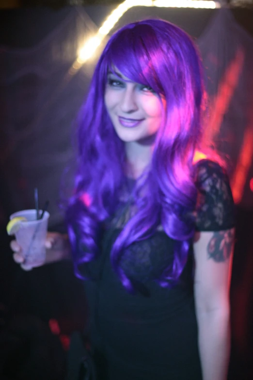 a girl with long purple hair drinking from a cup