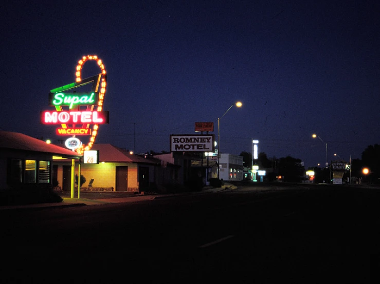 the neon sign for a el in the night