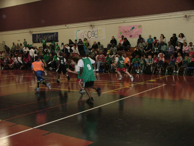 two s in green are playing basketball against each other