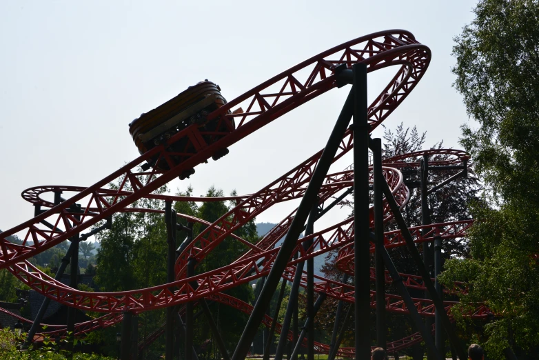 a roller coaster is shown with trees around