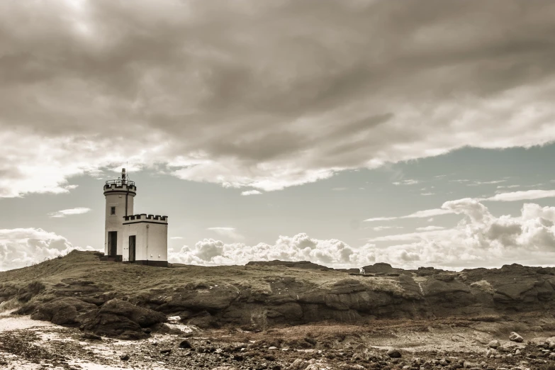 a white lighthouse sitting on top of a mountain