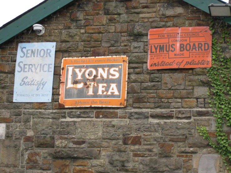 three signs that are on the side of a building