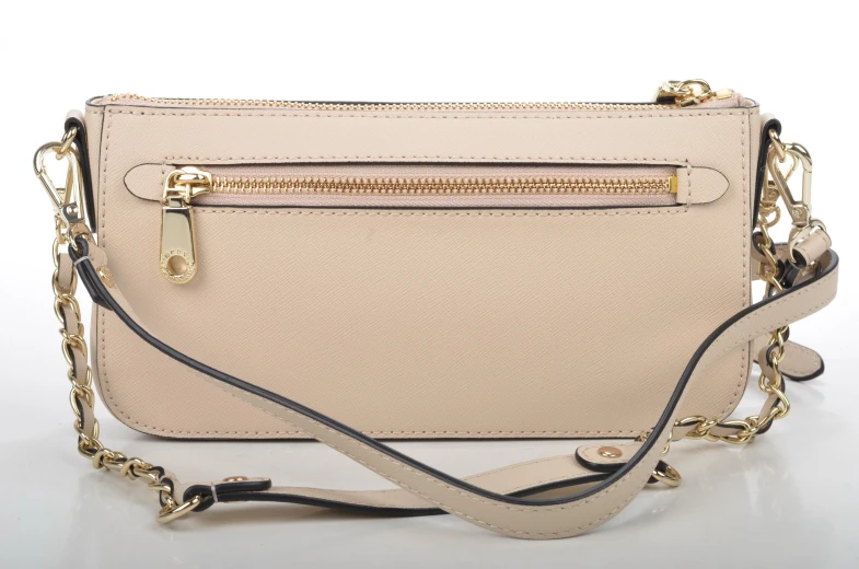 the front of a cross - body purse with gold zippers