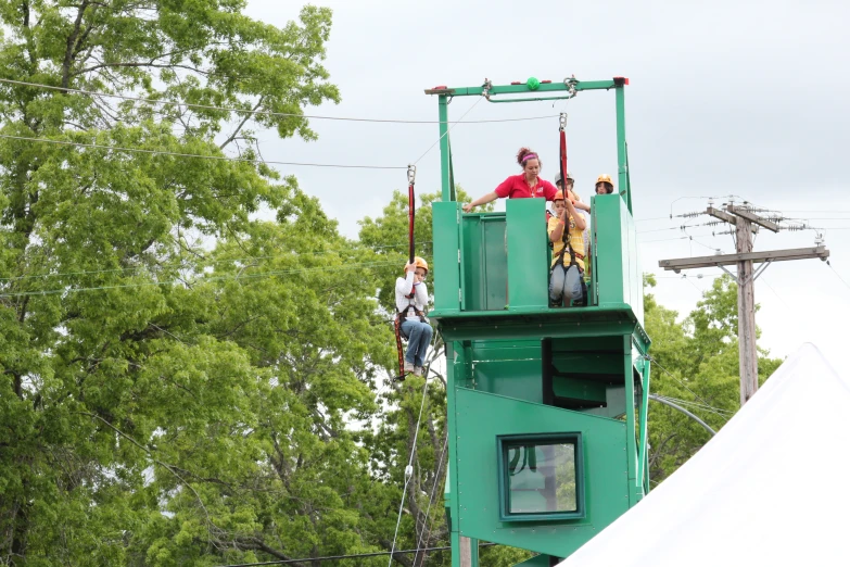 people riding on the side of a roller coaster