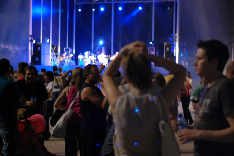 a crowd of people dancing in a dimly lit area