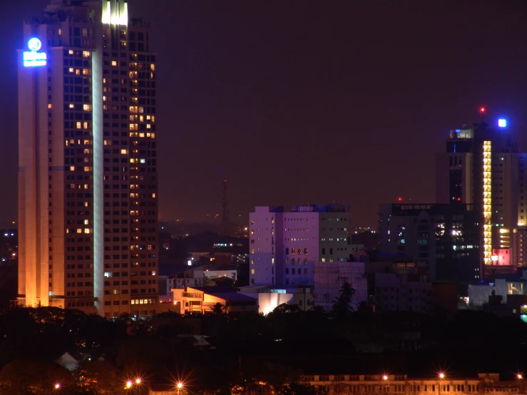 a city skyline with high rise buildings at night