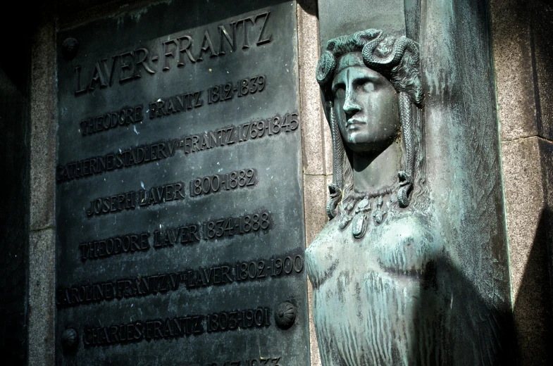 a memorial with writing and bust of a man