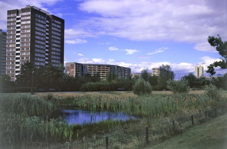 a very large tall building next to a lake