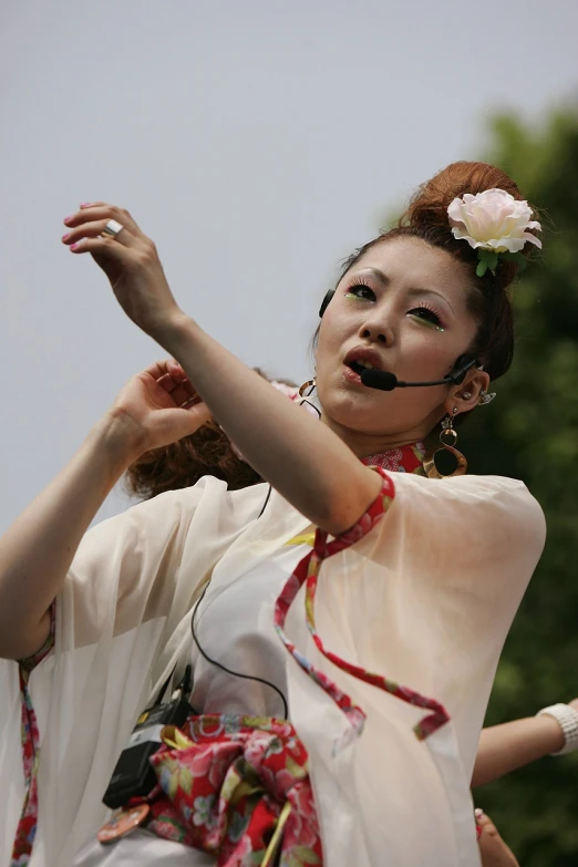 a woman in white dress holding out her arms