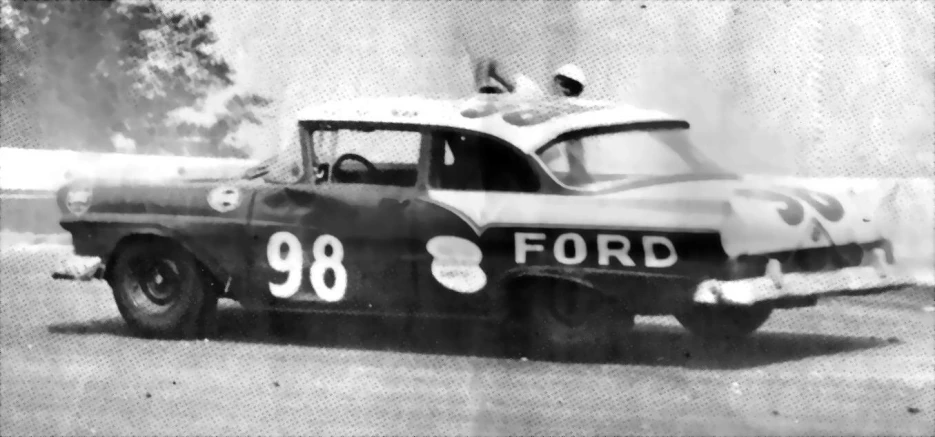 an old picture of a racing car on the track