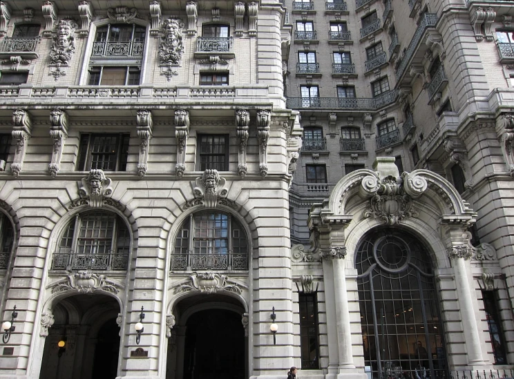 people are walking outside of an ornate building