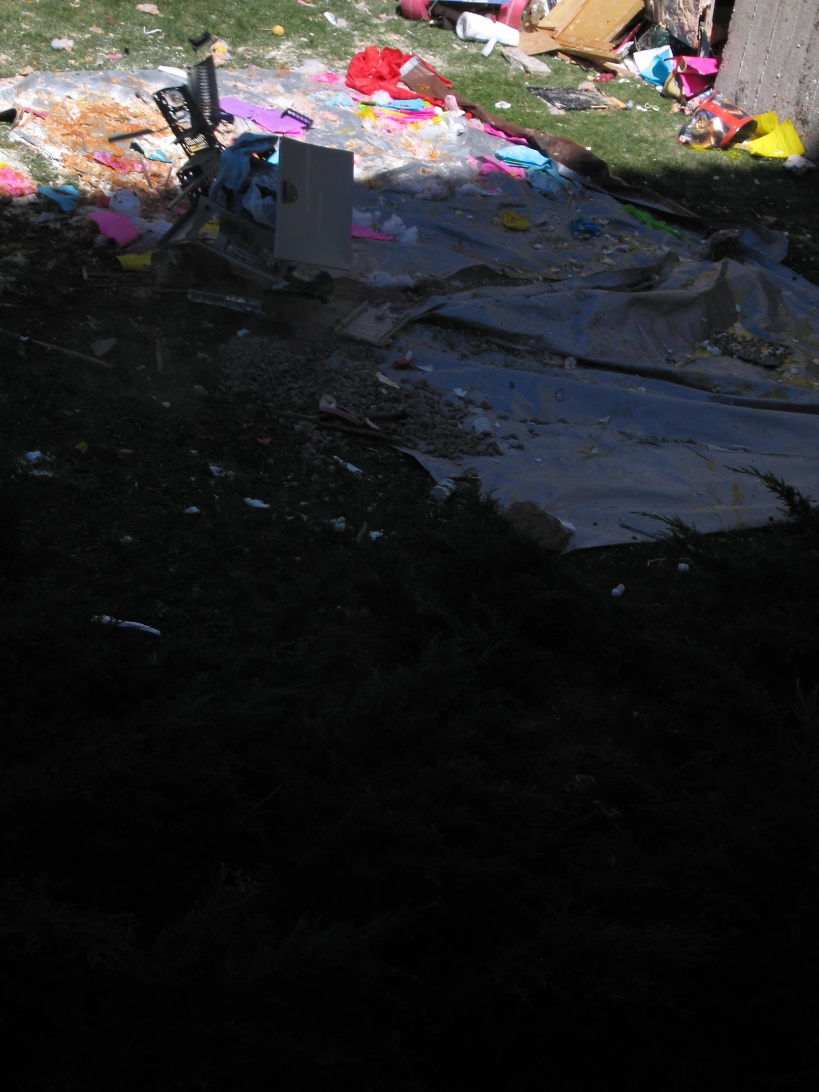 the large piece of material covers the ground near the trash pile