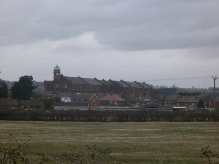 a building complex and a large clock tower in the distance