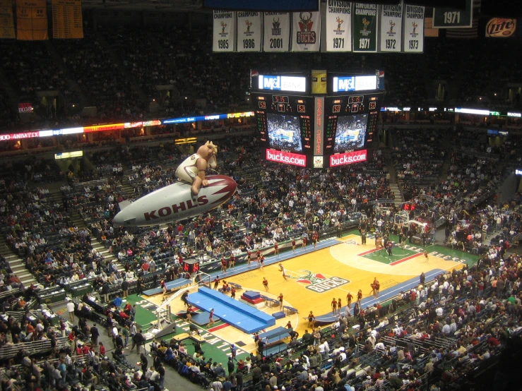 an audience at a sporting event watching a basketball game