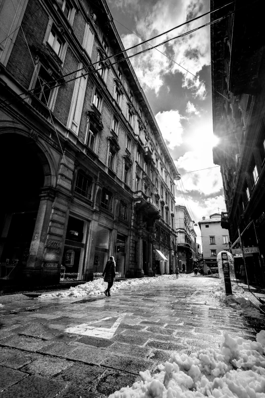 the man is walking in the street with an umbrella in hand