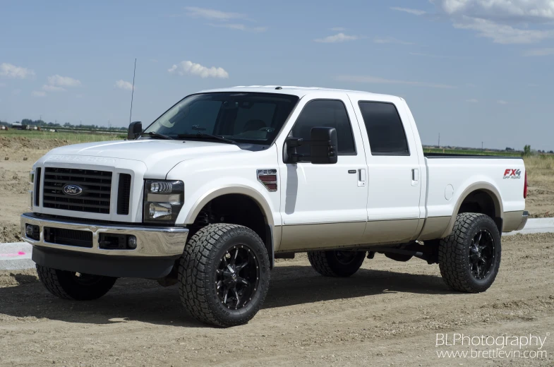 the white lifted ford super duty truck in the desert