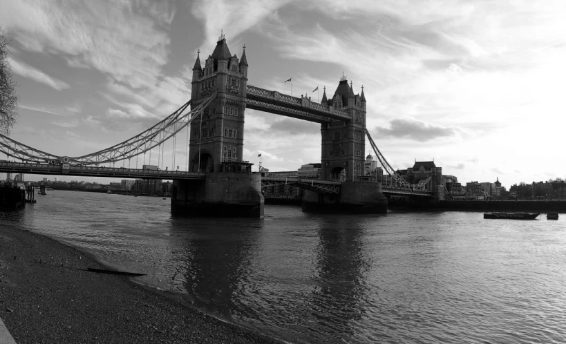 a tall bridge is across from a body of water