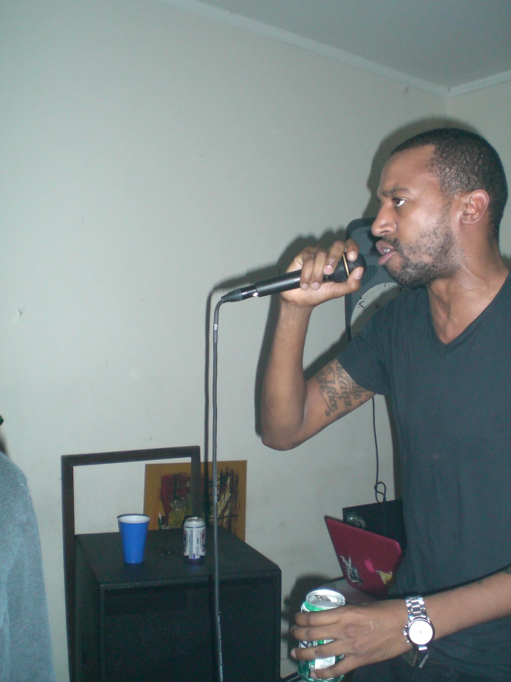 a man in black singing into a microphone