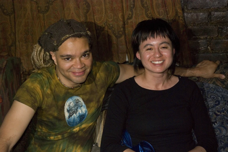 a man and woman sitting together on the couch