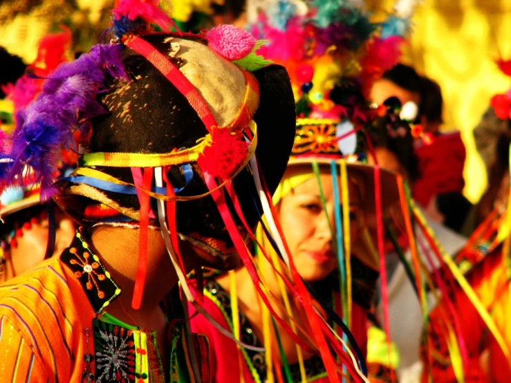 people wearing colorful headdress and costumes at an event