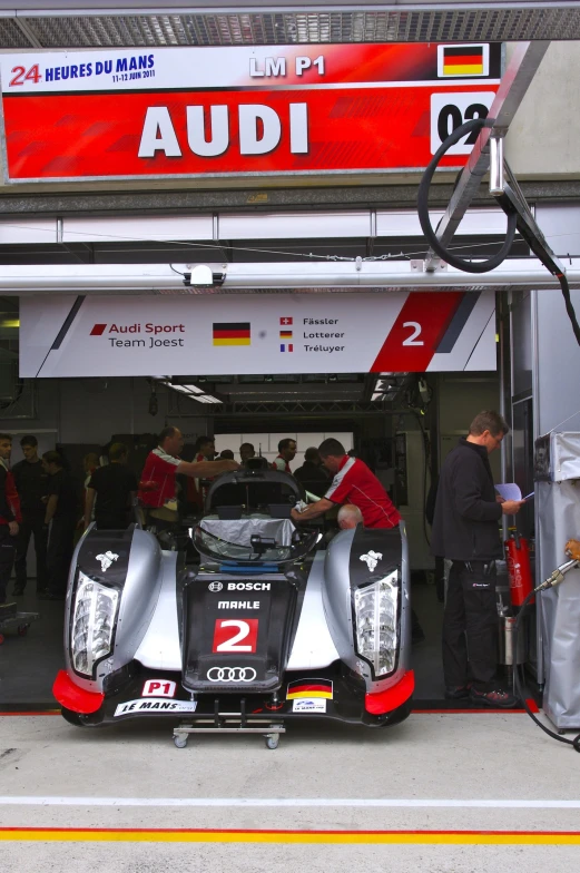 a racing car sits on the pit at the race