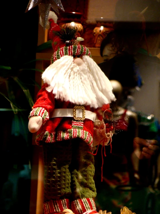 a toy santa claus doll laying on a shelf