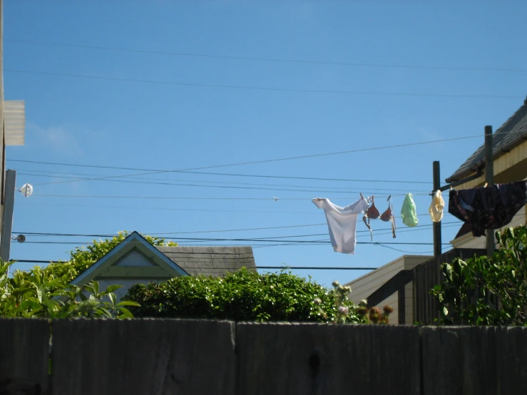 clothes hanging on wires in front of buildings