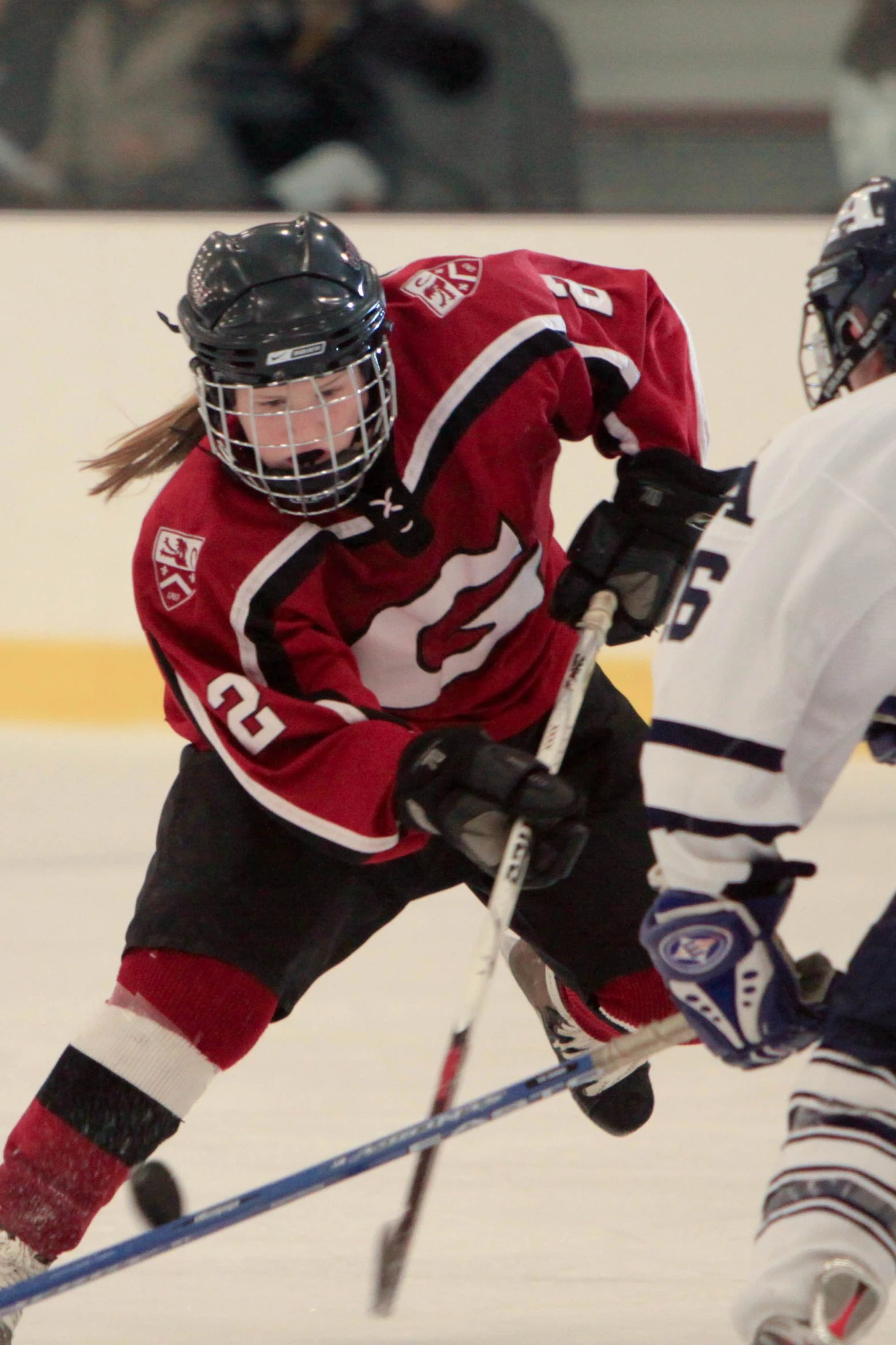 the hockey players are going for a puck on the ice