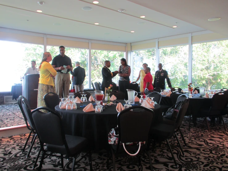 a crowd of people gathered around a banquet table