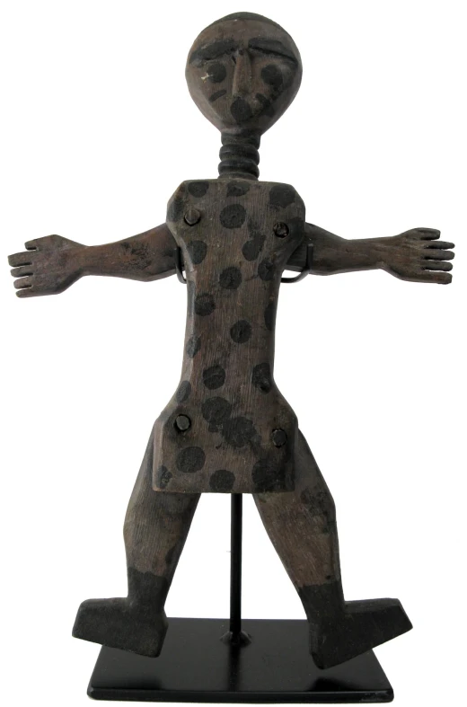 a statue made out of wood with polka dots